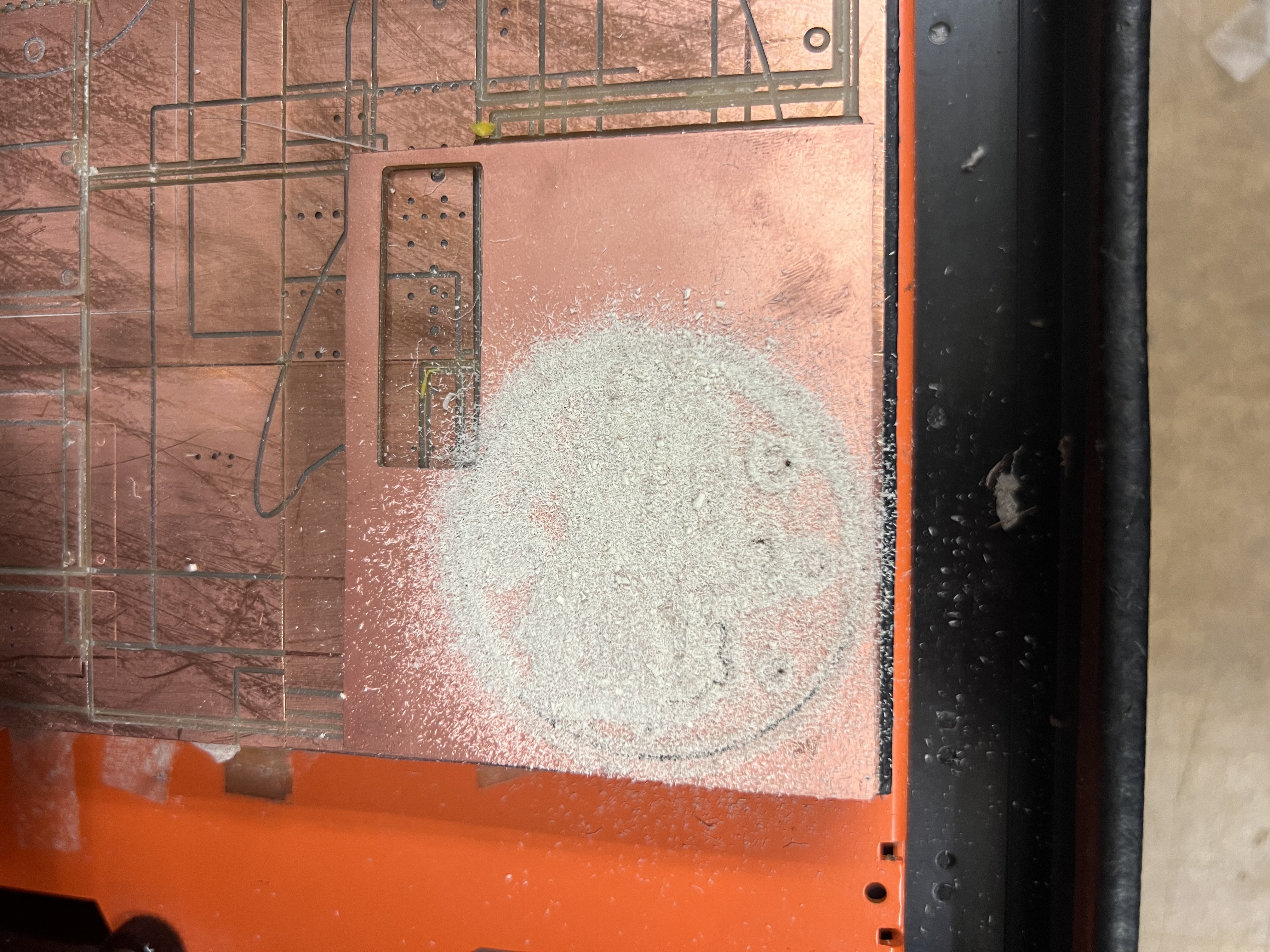 Board covered in white powder while milling